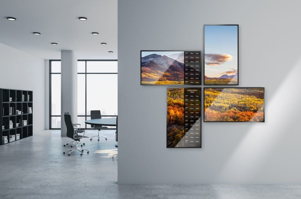 A contemporary office featuring a sizable wall-mounted TV. Digital signage.
